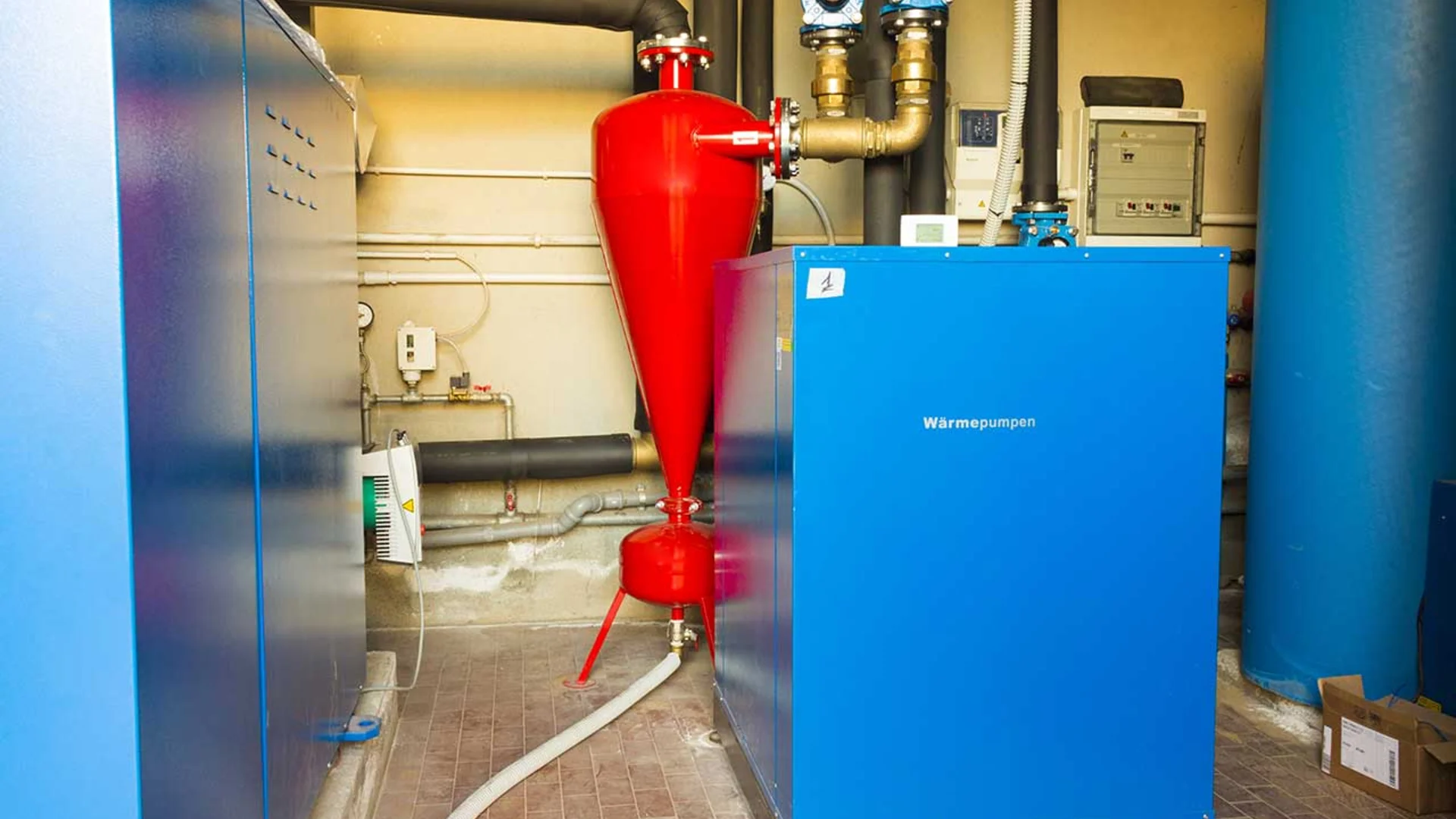 Geothermal heat pump system installed in a residential basement utility room